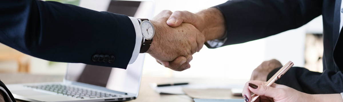 Corporate handshake to represent a procurement process and bidding documentation